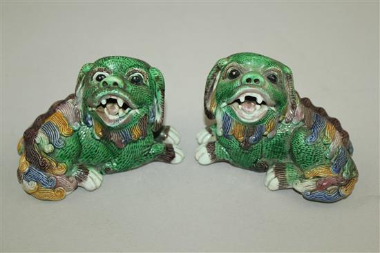 A pair of Chinese famille verte glazed biscuit figure of recumbent lion-dogs, 19th century, 10cm